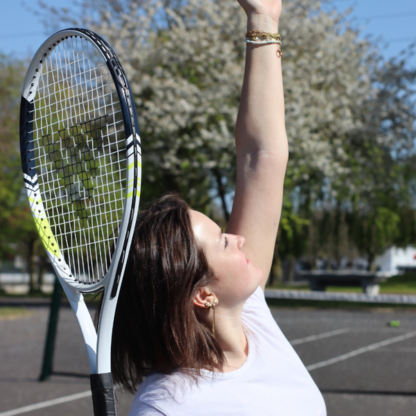 A Women playing Tennis using the Hit Sport Aluminium Tennis Racket