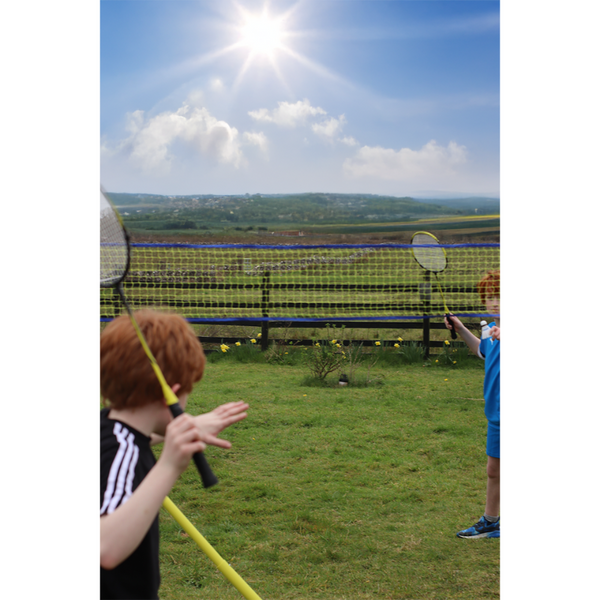 Children playing outside with the Hit Sport Aluminium & Fibreglass Badminton Racket