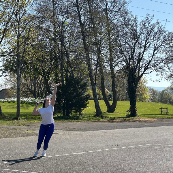 A Women playing Tennis using the Hit Sport Aluminium Tennis Racket