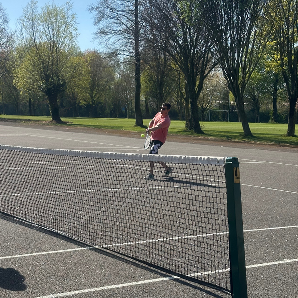 A Guy playing Tennis using the Hit Sport Aluminium Tennis Racket