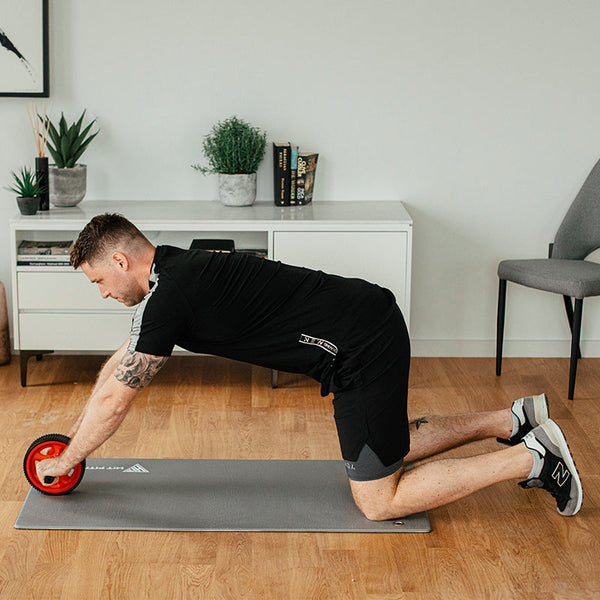 ab roller exercises to build a core strength on exercise mat 