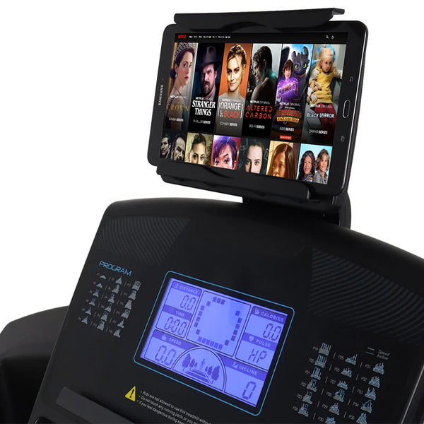The image shows the console of a HIT Fitness treadmill with a Samsung tablet mounted on it. The tablet displays a Netflix interface with several TV series thumbnails, while the treadmill's console shows stats like distance, time, speed, calories, pulse, and incline settings.