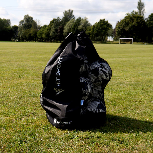 Hit Sport Mesh Panelled Ball Bag in Black placed on a Soccerpitch