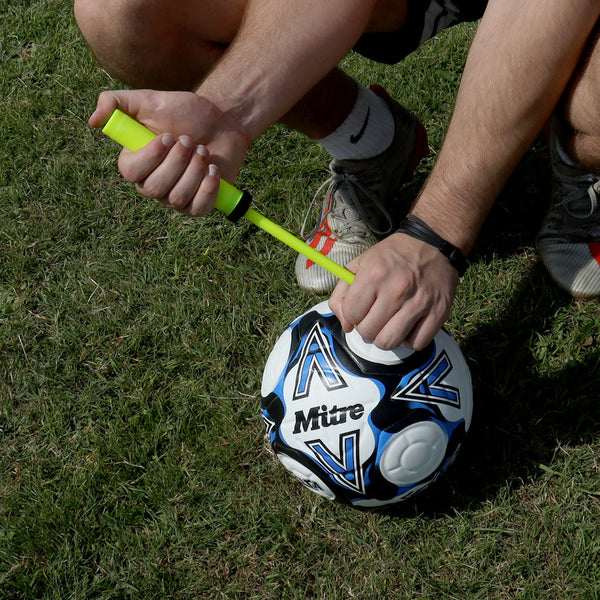 A Guy using the Hit Sport Training Hand Pump on a Soccer Ball