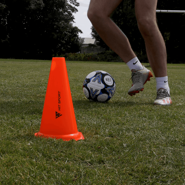 A Guy doing exercises with the Hit Sport 4-Pack Training Traffic Cone (12in / 30cm)