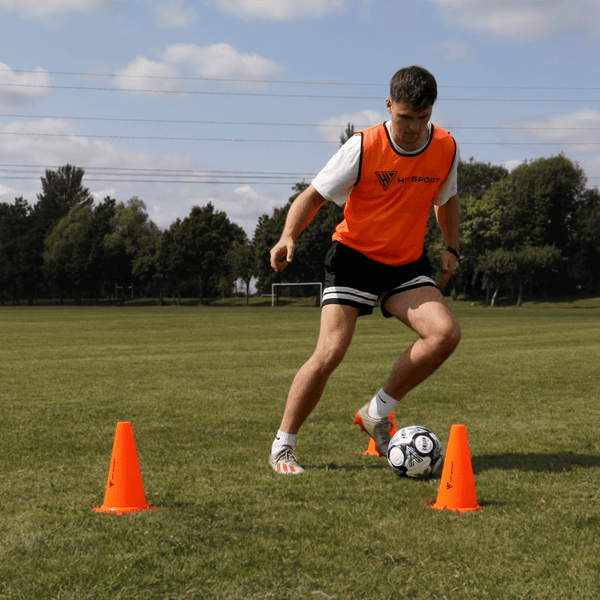 A Guy doing exercises with the Hit Sport 4-Pack Training Traffic Cone (9in / 23cm)