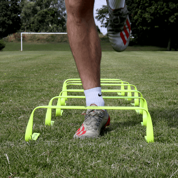 A Guy doing exercises using the Hit Sport Agility Hurdles 6 Pack (6 Inch / 15cm)