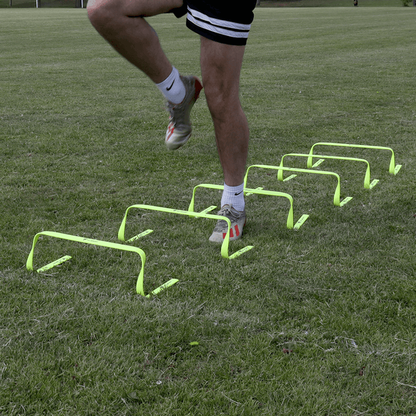 A Guy doing exercises using the Hit Sport Agility Hurdles 6 Pack (6 Inch / 15cm)