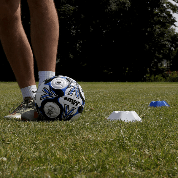 Hit Sport Hexagonal Space Marker Cone placed next to Guy on a Soccer Pitch