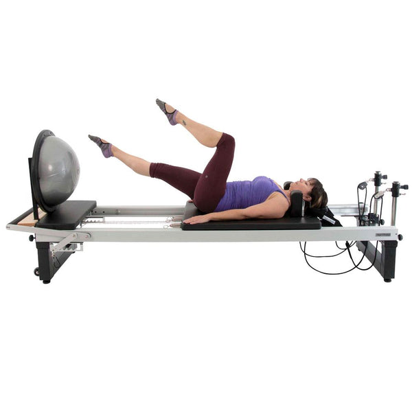 Woman doing leg raises on a Align Pilates A8 Pro Reformer