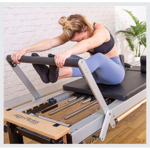 Woman doing stretches on an Align Pilates A8 Pro Pilates Reformer