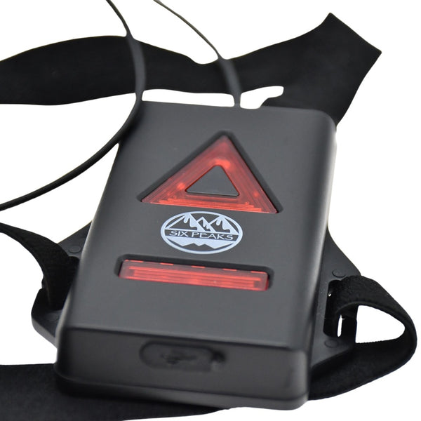 Close-up of the rear red LED lights and Six Peaks logo on the battery pack of the Running LED Chest Lamp.