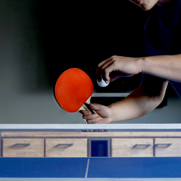 A Guy playing Hit Sport Table Tennis