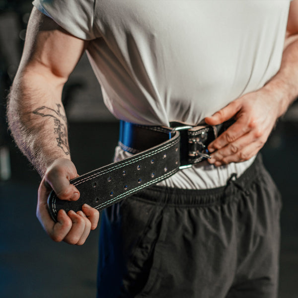 A Guy adjusting the Hit Fitness Leather Weightlifting Belt