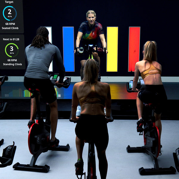Indoor cycling class performing a standing climb