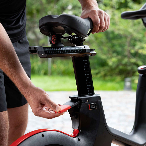 A guy adjusting the Life Fitness ICG IC7 Indoor Cycle