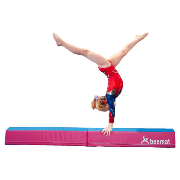 young Gymnast doing hand stands on a Balance Mat