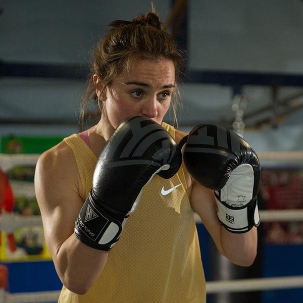 Female boxer wearing a Hit Boxing Leather Boxing Gloves