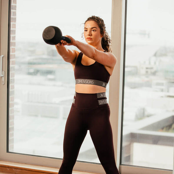 Hit Fitness Cast Iron Kettlebell | 28kg - woman holding Kettlebell