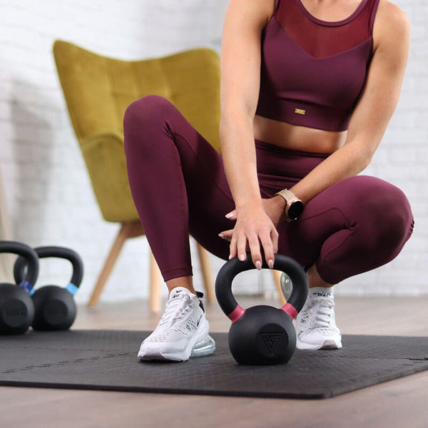 Hit Fitness Cast Iron Kettlebell | 32kg - Woman holding Kettlebell