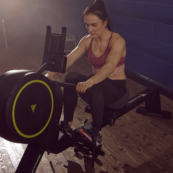 Woman Doing Exercise On Rowing Machine
