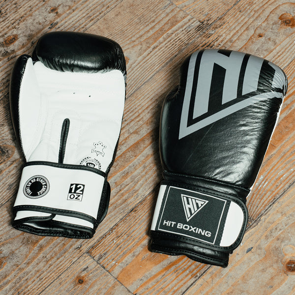 Hit Boxing Leather Boxing Gloves resting on a wooden floor