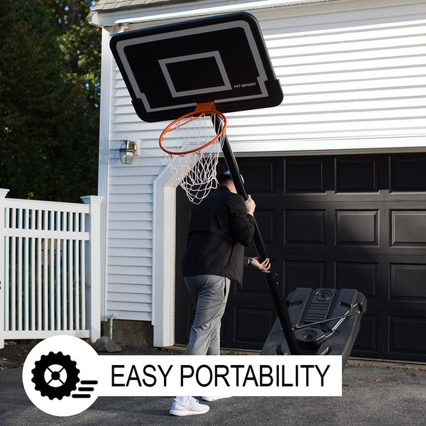 Man mounting the Hit Sport Portable Adjustable Basketball Unit outside his garage