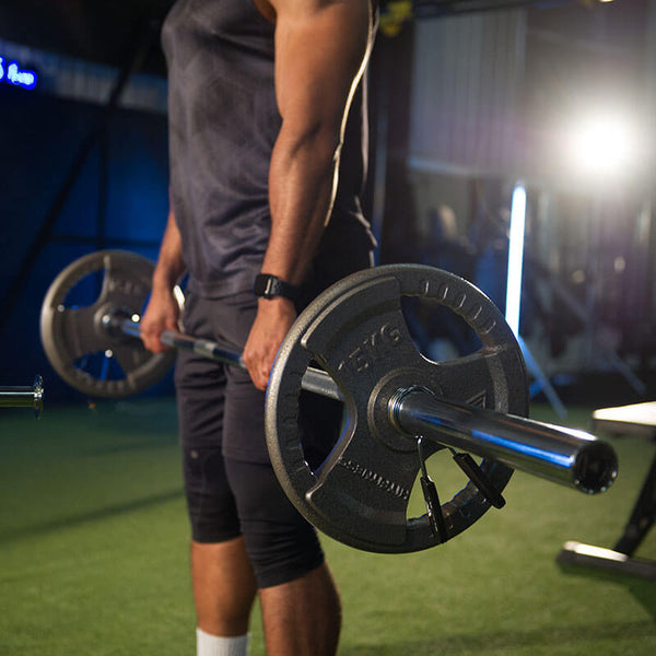 Olympic Cast Iron Tri-Grip Disc | 15kg - Man exercising
