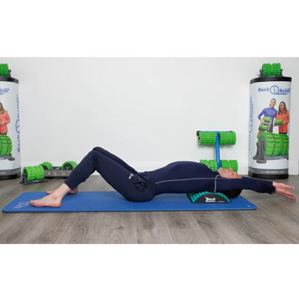 A Guy doing exercises with The Hog Back Stretcher